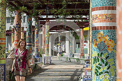 Classical tiled artistic spanish corridor with column in garden square. Art design attraction in landmark. Tile pillar in plaza Stock Photo