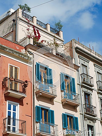 Classical vintage facades with colourful windows and balconies downtown Cagliari, Sardinia island, Italy. Vertical photo Stock Photo