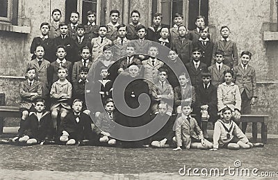 Classphoto showing teenage boys class around 1930 with their priest teacher, clearly a boys only school, Antwerp Editorial Stock Photo