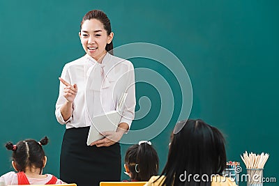 In classroom, Asian teacher teaches student Stock Photo