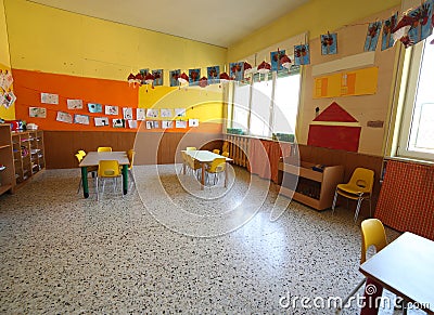 classroom of a childhood nursery with drawings and the tables Stock Photo