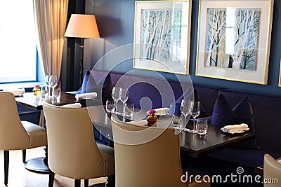 Classy elegant and modern restaurant at Amsterdam, The Netherlands in Europe. Seats, tables and lamps at luxury premium hotel. Editorial Stock Photo