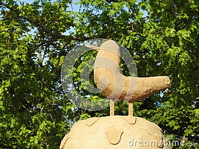 Clay bird in park near trees, Lithuania Stock Photo