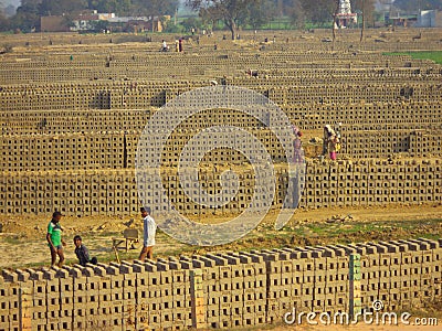 Clay bricks getting dried at a Brick Kiln Editorial Stock Photo