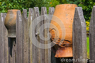 Clay brown jugs on a rural fence Stock Photo