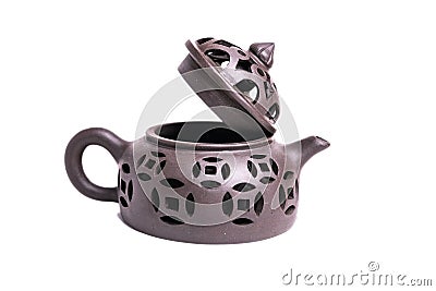 Clay Chinese teapot with carved patterns isolated on a white background Stock Photo