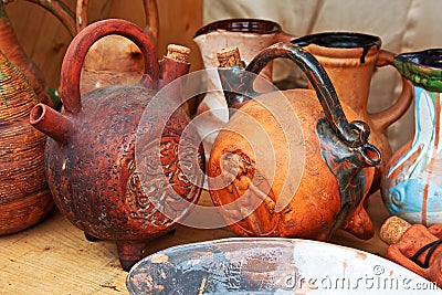 Clay folk jugs stand on a shelf. Rural handmade, craft, ceramics, ethnic, folk pitchers. Stock Photo