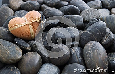 Clay Heart on Stones Stock Photo