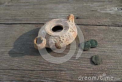 Clay Lamp with Roman Coins Stock Photo