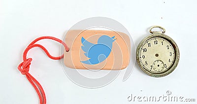 clay plate and vintage clock with logo of twitter Editorial Stock Photo