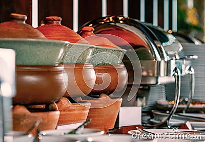 Clay pot heat up the food at buffet line Stock Photo