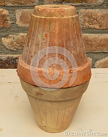 Clay pot placed upside down on anther pot. aged terracotta pots Stock Photo