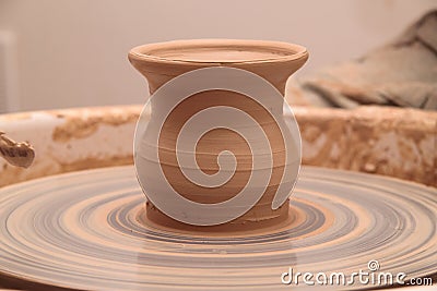 Clay pot on a pottery wheel Stock Photo