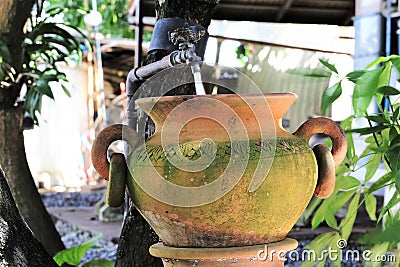 Clay pot use as zink in the gargen Stock Photo