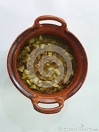 Clay pots filled with pork rinds in green sauce Stock Photo