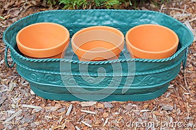 Clay Pots in Metal Container Stock Photo