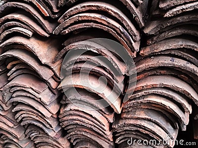 Clay tiles in a stacked pile, three columns, for traditional roof construction Stock Photo