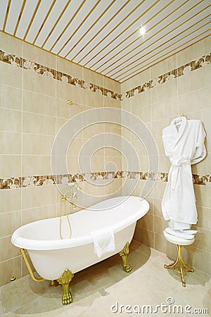 Clean bathroom with bath and bathrobe in classic style. Stock Photo