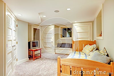 Clean and bright basement bedroom with white walls and carpet. Stock Photo