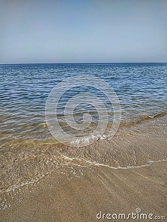Clean clear beach sand in and calms sea wave , Muscat, Oman Stock Photo