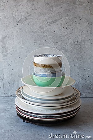 Clean dishes on the table in a stack on a gray background Stock Photo
