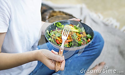 Clean eating, vegan healthy salad bowl closeup , woman holding salad bowl, plant based healthy diet with greens, salad, chickpeas Stock Photo