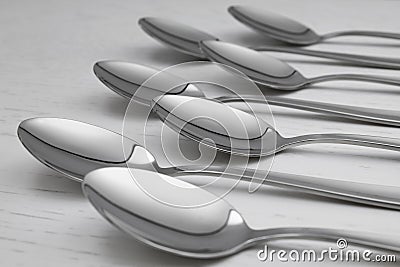 Clean empty table spoons on white background Stock Photo