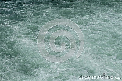 A clean but foamy water surface with emerald color tone Stock Photo