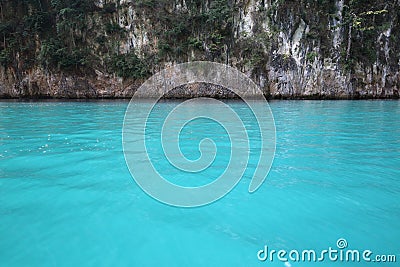 Clean green water of Ratchaprapa dam infront of the cliff Stock Photo