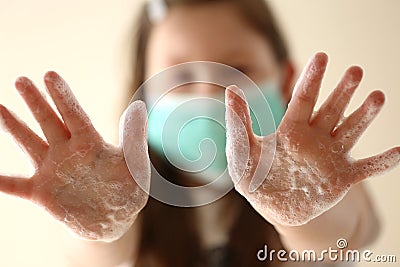 Clean hands concept. Hand washing.Girl in a medical protective mask Stock Photo