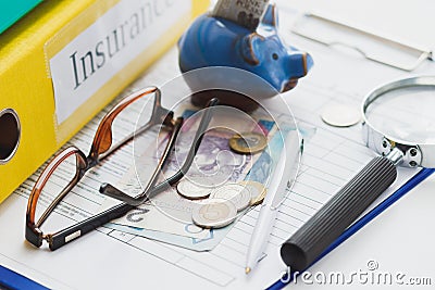 Clean insurance blank, Polish zloty, magnifying glass, glasses and piggy bank Stock Photo