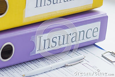 Clean insurance form, colored folders and a pen Stock Photo