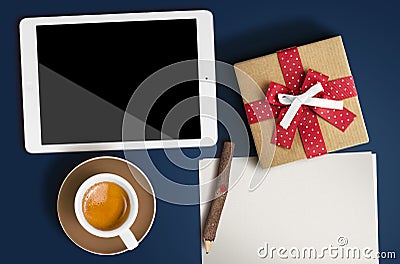 A clean sheet of paper, coffee, tablet and a wooden pen lay on b Stock Photo