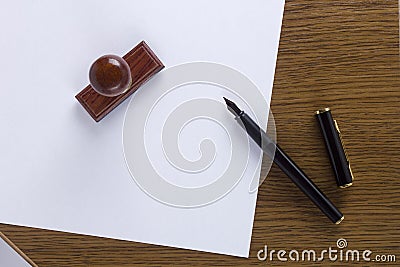 Clean sheet of paper and a pen wooden stamp Stock Photo