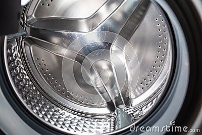 Clean shiny scratch on the drum of the washing machine closeup. The concept of cleaning appliances from scale Stock Photo