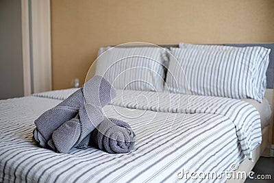 Clean stack of towels in hotel bedroom Stock Photo
