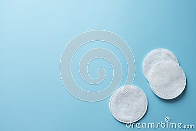 Clean white cotton stack of disk for beauty face hygiene with selective focus on blue neutral background. Cosmetic softness pure Stock Photo