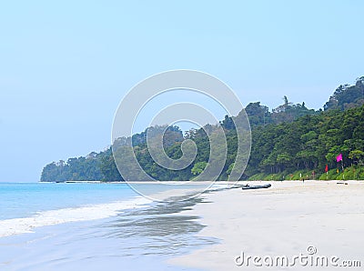 Clean White Sandy Beach, Blue Sea Water, Clear Sky, Colorful Flags, Boat and Clear Sky - Radhanagar Beach, Havelock Island, India Stock Photo