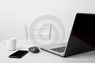 Clean workplace with laptop,phone,coffee cup and computer mouse Stock Photo