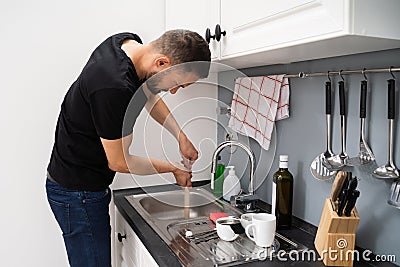 Cleaning Blocked Drain Clog In Kitchen Sink Stock Photo