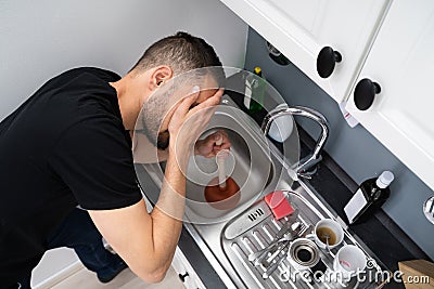 Cleaning Blocked Drain Clog In Kitchen Sink Stock Photo