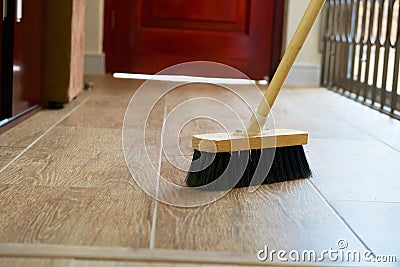 Cleaning broom on wooden floor Stock Photo