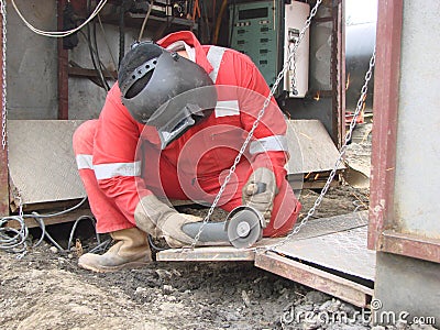 Cleaning with the Bulgarian of a sheet of iron Stock Photo