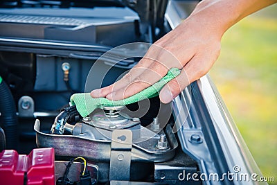 Cleaning the car engine with green microfiber cloth Stock Photo