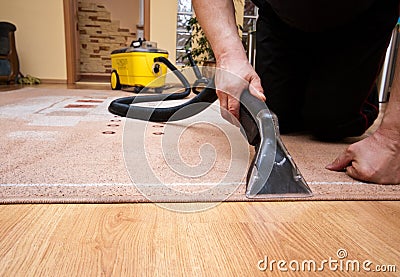 Cleaning carpet services detail with yellow machine Stock Photo