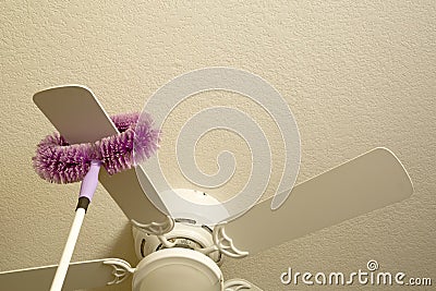Cleaning ceiling fan Stock Photo