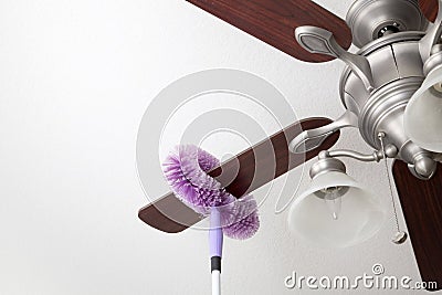 Cleaning ceiling fan Stock Photo