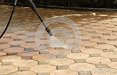 Cleaning concrete block floor Stock Photo