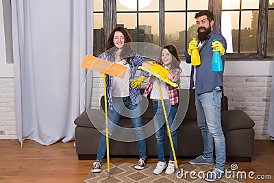 Cleaning day. Family mom dad and daughter with cleaning supplies at living room. We love cleanliness and tidiness Stock Photo