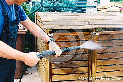 cleaning dirty wooden garden garbage with a high-pressure cleaner Stock Photo